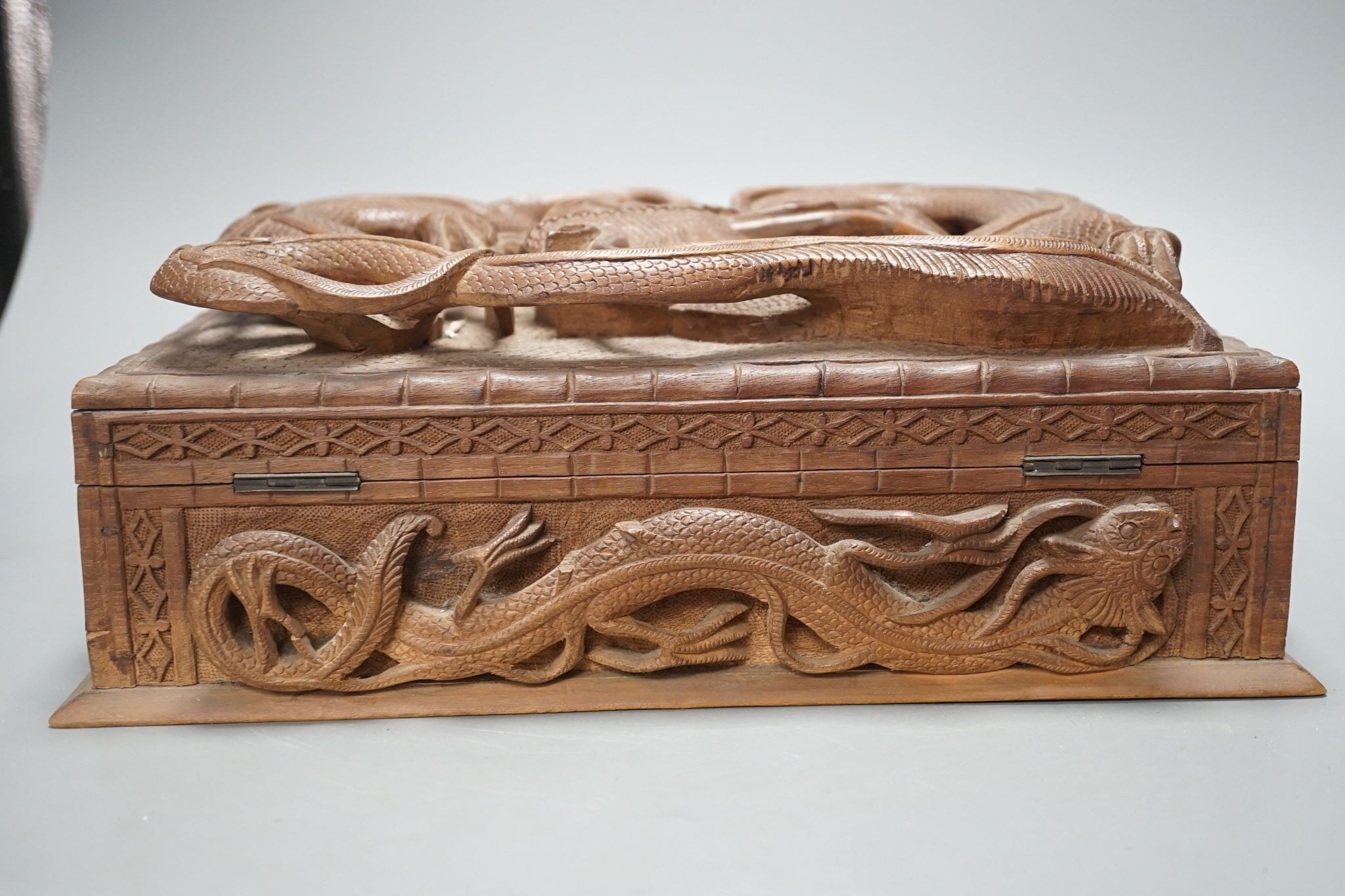 A Burmese carved wood 'Dragon' box, 31cm wide